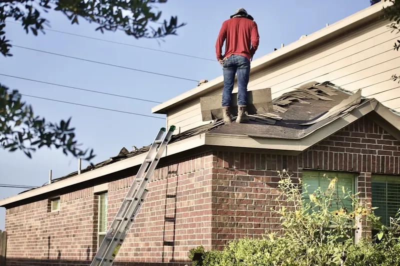 Professional roofer working on a residential roof in North Tonawanda